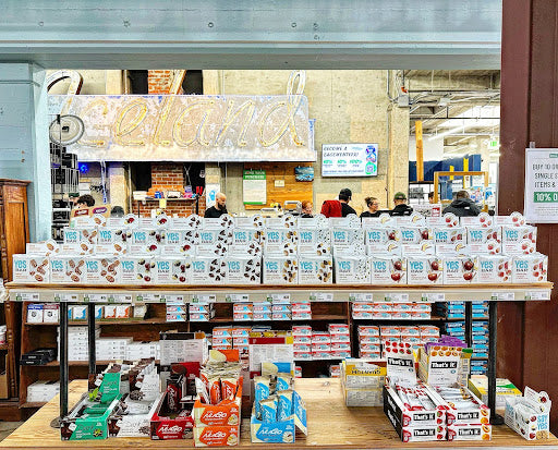 A variety of YES Bars displayed at Sports Basement in Berkeley, featuring plant-based snacks.